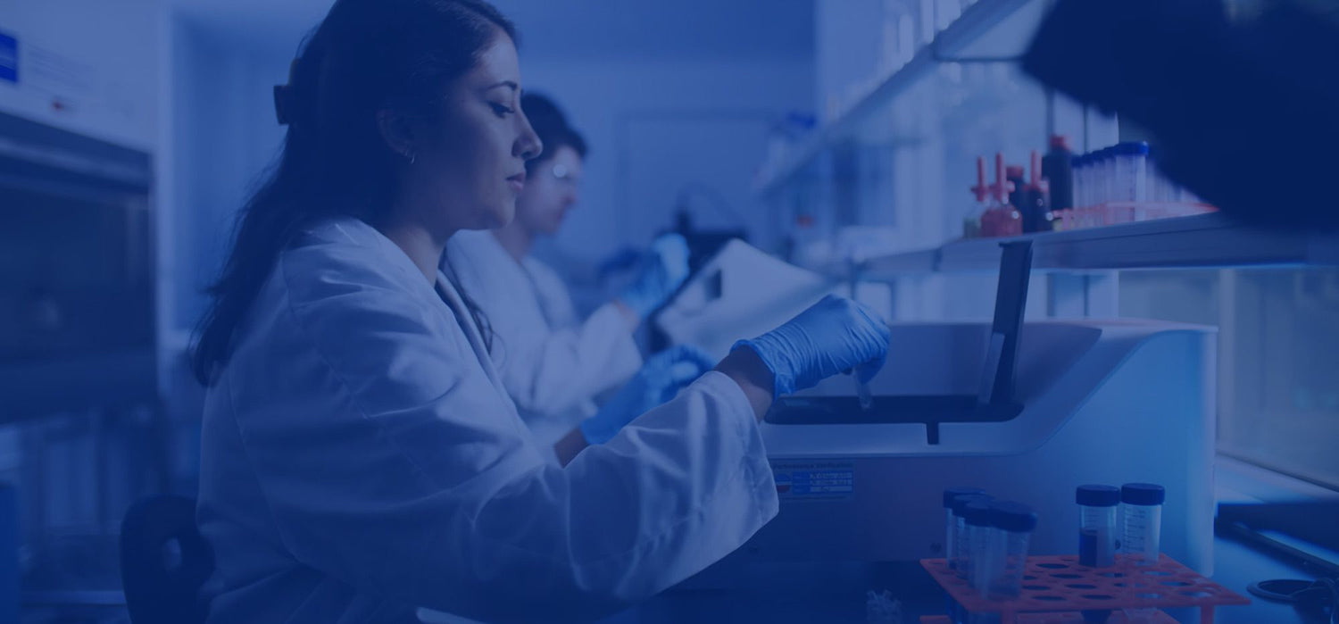 Scientists working in a laboratory with equipment and test tubes.