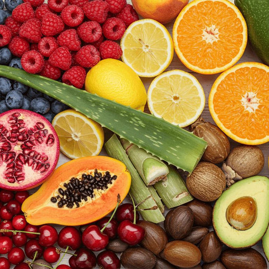Assorted fruits and vegetables including berries, citrus, and nuts on a wooden surface.