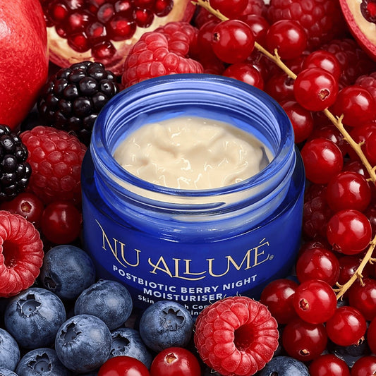 Open jar of Nu Allumé Postbiotic Berry Night Moisturiser surrounded by berries
