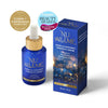 Nu Allumé Rosella Radiance Prebiotic Serum in a blue dropper bottle with a gold collar, shown next to its blue packaging box. Two award badges are displayed in the top left corner on a clean white background. Clean and Conscious Awards Gold Winner 2026 and Prevention Beauty Awards Winner 2026.